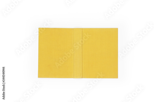 Open hard cover yellow book on white background