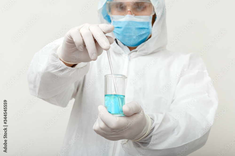 Covid-19 vaccine. Doctor or scientist in protective medical suit, biological hazard, face mask creating coronavirus vaccine in laboratory. Medical healthcare pandemic prevention concept Covid-19 vaccine. Doctor or scientist in protective medical suit, biological hazard, face mask creating coronavirus vaccine in laboratory. Medical healthcare pandemic prevention concept