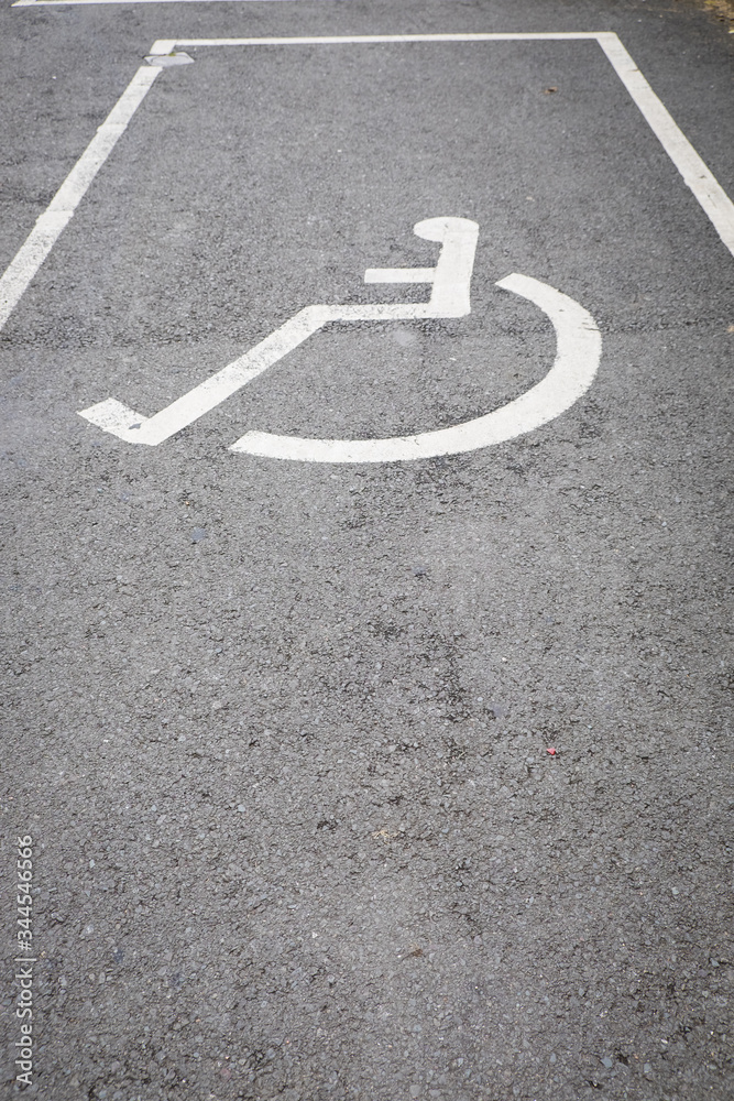 Obraz premium A sign on the pavement - disabled car parking