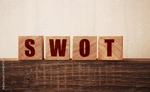 the word of SWOT on wooden cubes. Strengths weaknesses, opportunities, treats analysis bysiness concept photo