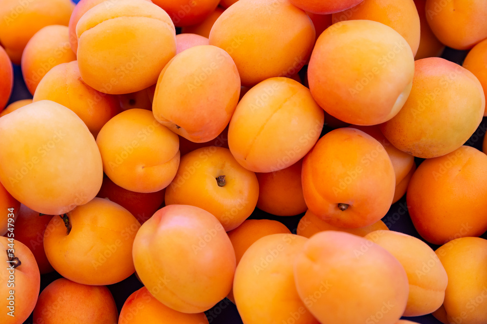 Ripe apricots fruit on a street fruit vegetables market, ecological food, background