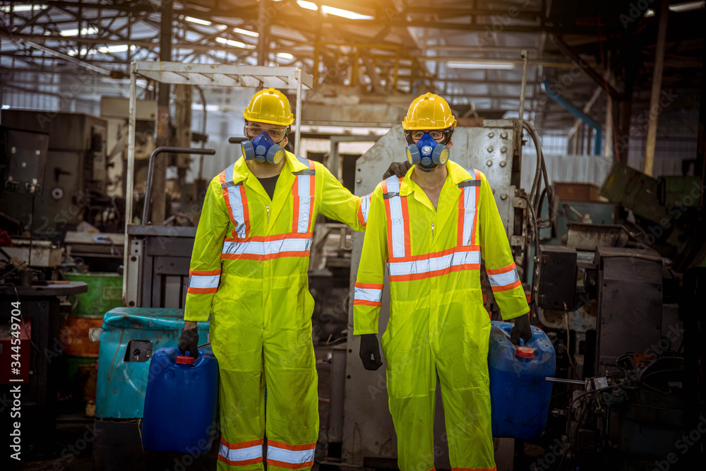 A worker industry wearing safety uniform ,black gloves and gas mask under checking chemical tank in industry factory work. A worker industry wearing safety uniform ,black gloves and gas mask under checking chemical tank in industry factory work.