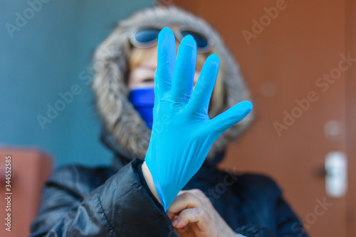 Elderly woman in gloves isolation disinfection