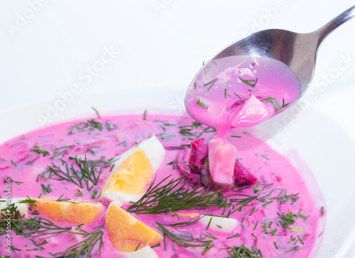 Traditional Lithuanian dish cold beets. Spoon with liquid. White background