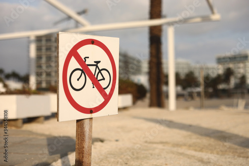 beach traffic sign not to enter with a bicycle. selective focus. the sign on the beach is prohibited by bicycle
