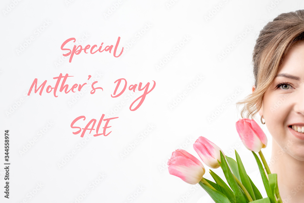 Portrait of smiling beautiful woman with pink tulips on white background with text Special Mother's Day Sale.