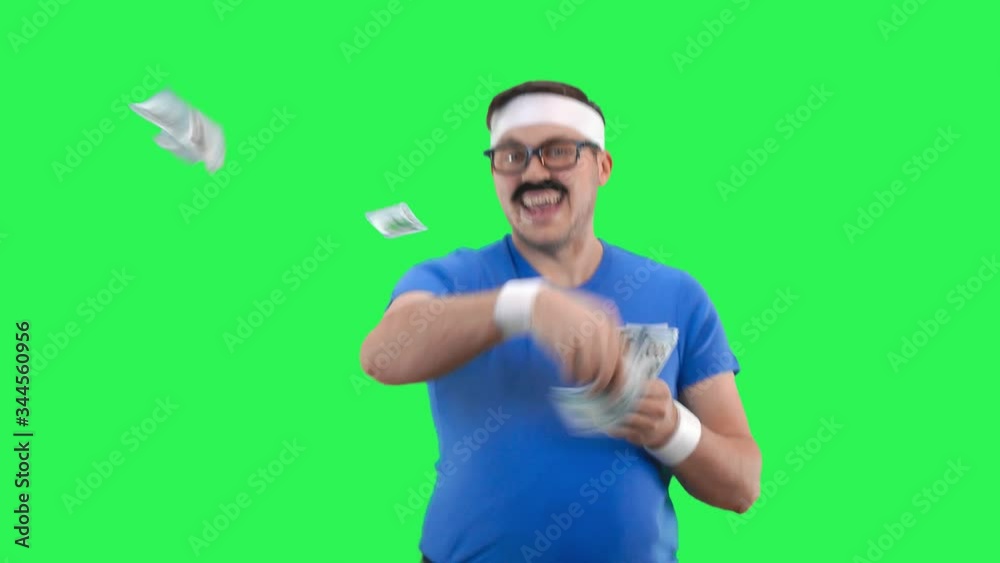 Athlete man holds money in his hands and scatters it to the side. Athlete man holds money in his hands and scatters it to the side.