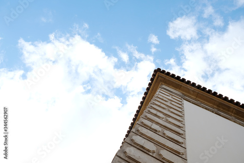 Corner of a building and sky and clouds above it. Architecture detail with copy space.