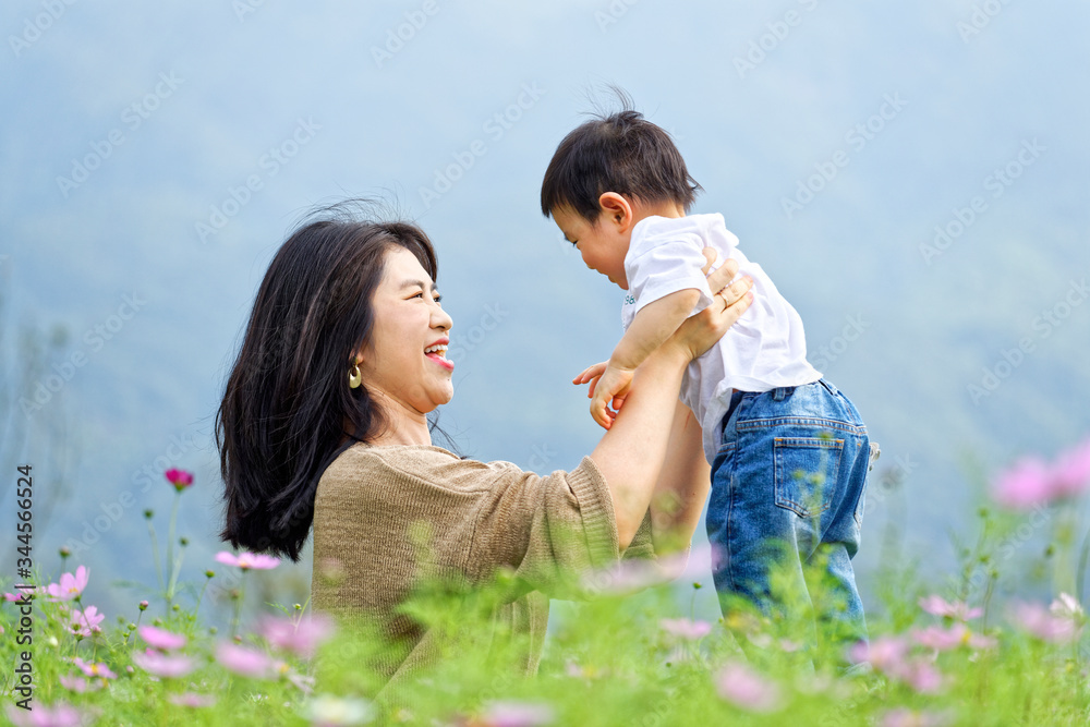 The mother took her boy to play outdoors
The mother took her boy to play outdoors