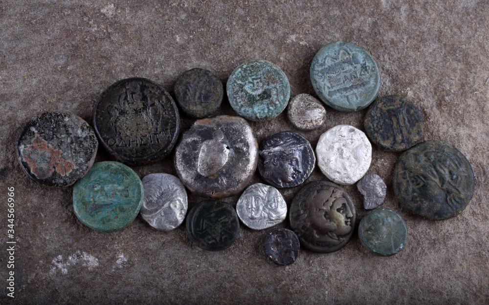 Ancient Greek coins on stone