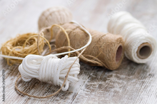 Rope balls of different types over a wooden background