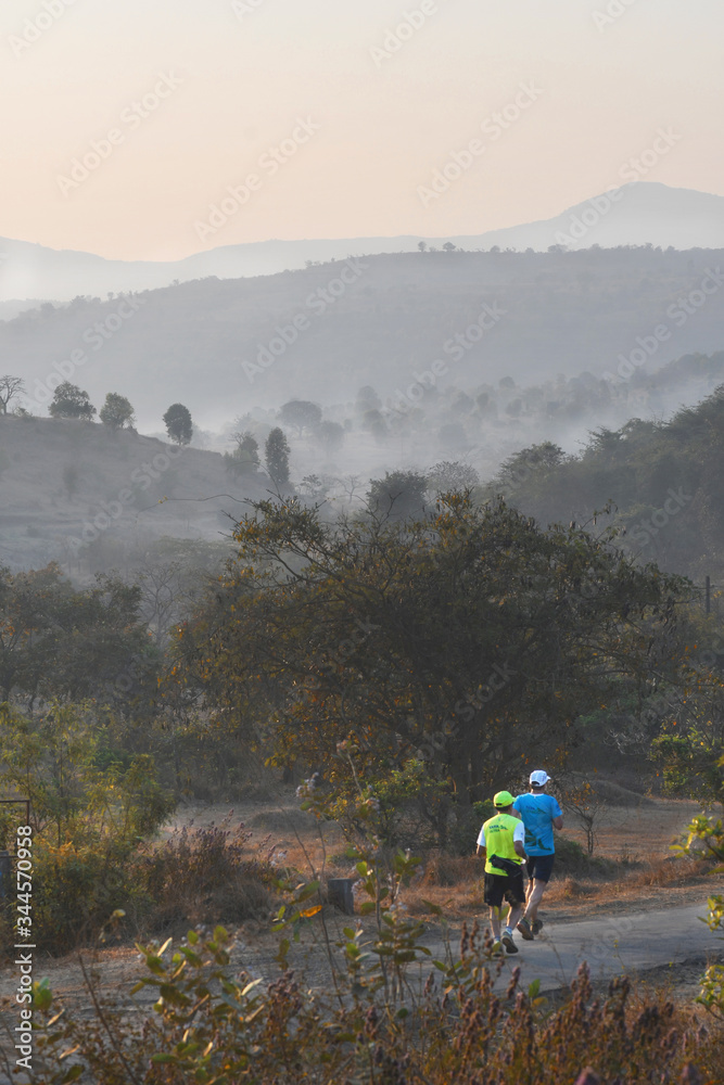 Obraz premium Running is a popular form of exercise. Today, many individuals are taking fitness seriously. Running in country side has many benefits.