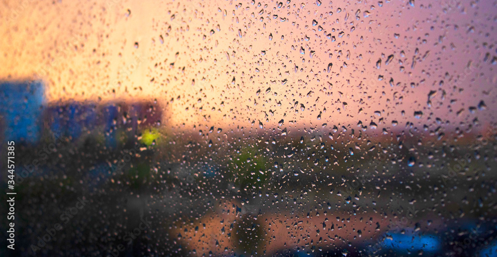 Raindrops on the window. Sunset, evening time in the city. Raindrops on the window. Sunset, evening time in the city.