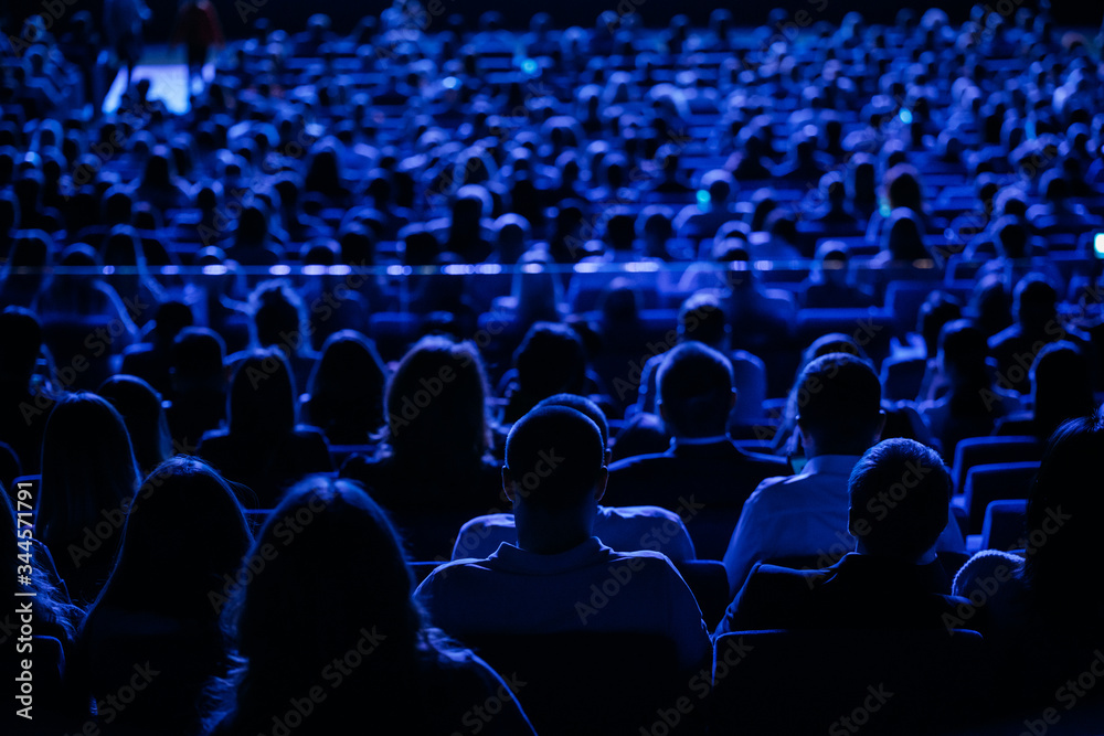 The audience in the cinema, the view from the back. Group of ...