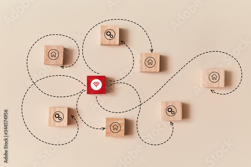 Work from home. Online distance working. Stay home. Wooden cubes with house, settings sign connected with red block