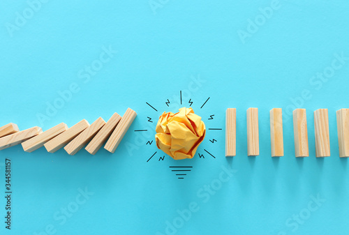 Education concept image. Creative idea and innovation. Crumpled paper as light bulb metaphor over blue background