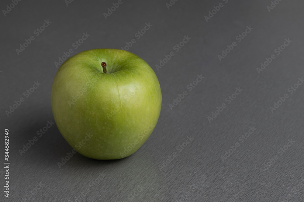 still life ripe fresh green granny apple on a gray background still life ripe fresh green granny apple on a gray background