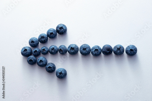 arrow shape from ripe blueberries on a white background