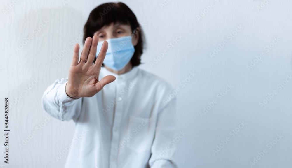 Coronavirus quarantine and Air pollution pm2.5 concept. Old sick woman wearing blue respirator mask for protect with outstretched arm. Wuhan, China epidemic virus symptoms background. Coronavirus quarantine and Air pollution pm2.5 concept. Old sick woman wearing blue respirator mask for protect with outstretched arm. Wuhan, China epidemic virus symptoms background.