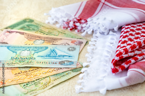 Arab Money Dirham Bank notes and Traditional Arab Male Scarf - kaffiyah close-up.