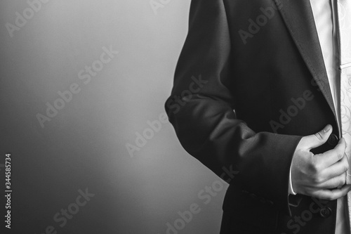 black and white photo of a man adjusting his watch. business management. classic clock.