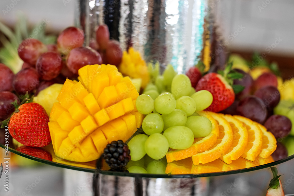 Fruit mix with orange, strawberry and blackberry, mango and grape. The concept of food, catering, restaurant and celebration. Fruit mix with orange, strawberry and blackberry, mango and grape. The concept of food, catering, restaurant and celebration.