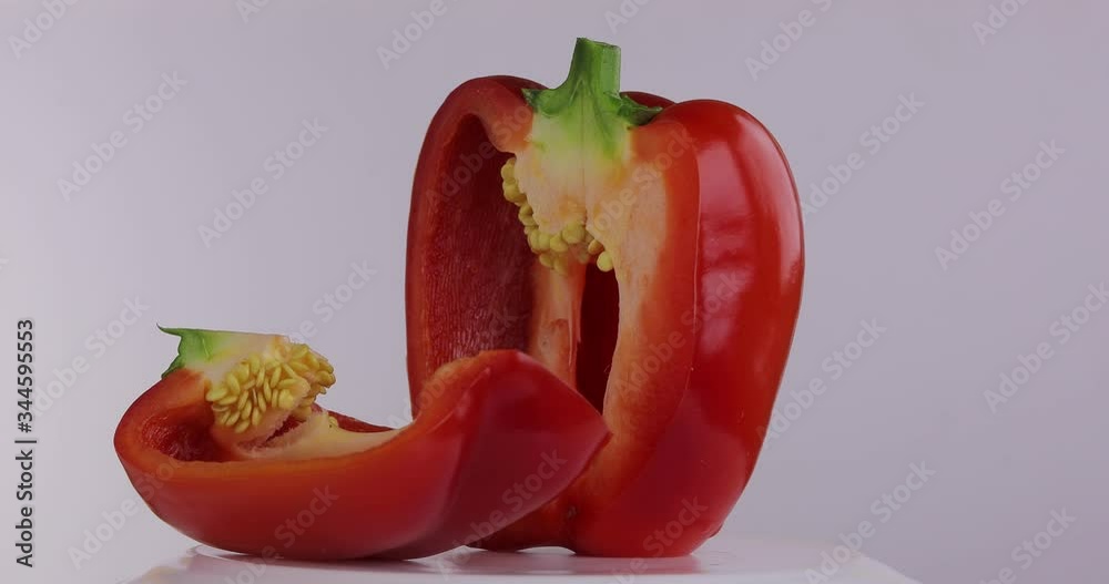 
Beautiful sliced ​​pepper. Vegetables are fresh, red, juicy, organic, vegetarian, sweet, spicy which rotates on a white background. 2 shots.