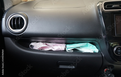 Surgical masks are placed in the glove compartment in the car console. 