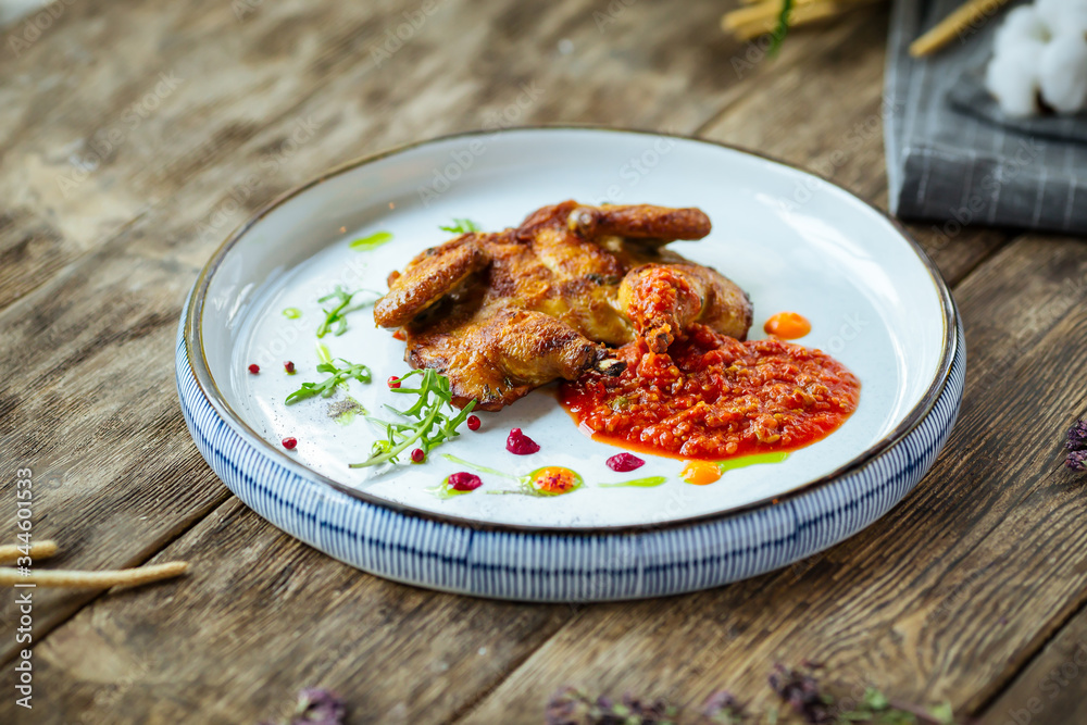 Gourmet roasted tobacco quail red pepper sauce 