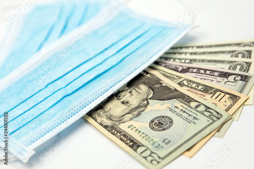 Surgical face masks and USA Dollar Banknotes, inflated export and import, mandatory masking photo