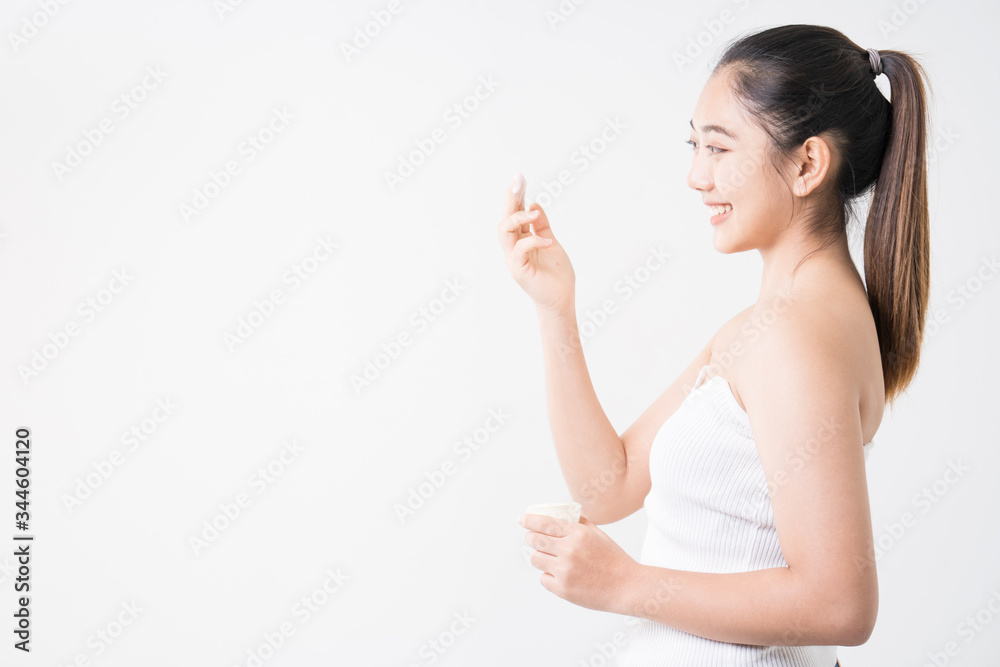 Young women experimenting with skin care creams. Two young woman applyng moisturizing cream. Beauty female with make up concept on the white background. Young women experimenting with skin care creams. Two young woman applyng moisturizing cream. Beauty female with make up concept on the white background.