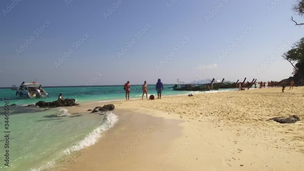 Ao Nang, Thailand - January 24, 2020: Bamboo Island is a popular tourist destination, so traditional longtail boats often bring here holidaymakers to swim and relax on Bamboo beach Ao Nang, Thailand - January 24, 2020: Bamboo Island is a popular tourist destination, so traditional longtail boats often bring here holidaymakers to swim and relax on Bamboo beach