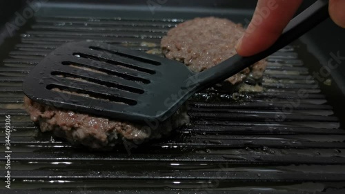 Grilled burgers toasting process. Kitchen concept.