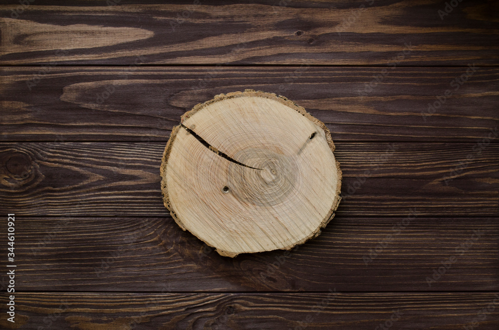 Cross section of tree trunk on wooden background Cross section of tree trunk on wooden background