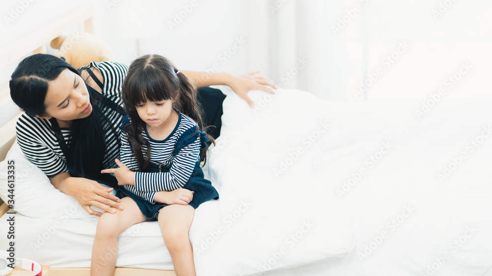 Mother soothing and comforting sad unhappy young daughter in the bedroom with copy space, mother-daughter relationship, mommy love, executive functions, child sadness, family relationship, parenting. Mother soothing and comforting sad unhappy young daughter in the bedroom with copy space, mother-daughter relationship, mommy love, executive functions, child sadness, family relationship, parenting.