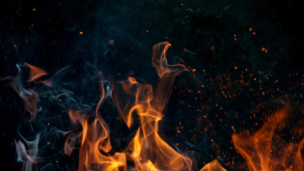 fire flames with sparks on a black background, close-up