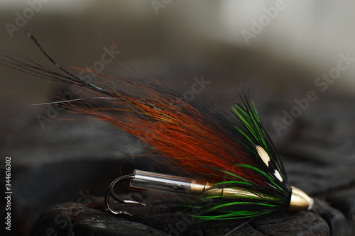 Obraz na płótnie Traditionally dressed salmon fly shot against a wood background w salonie