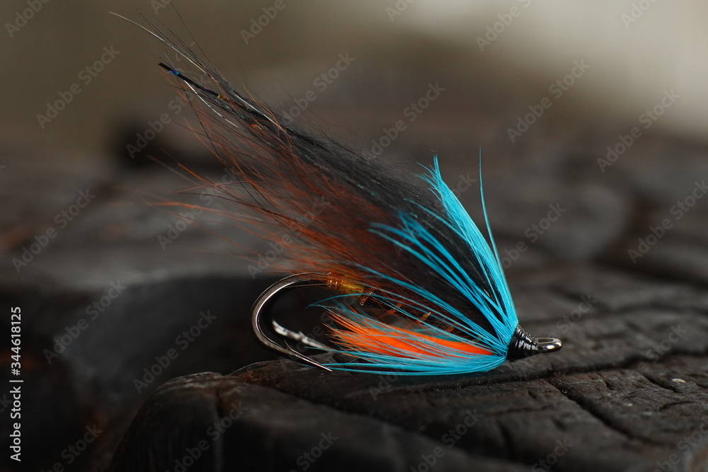 Traditionally dressed salmon fly shot against a wood background