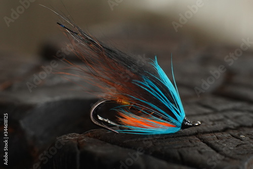 Obraz na płótnie Traditionally dressed salmon fly shot against a wood background w salonie