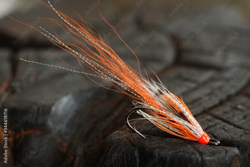 Traditionally dressed salmon fly shot against a wood background