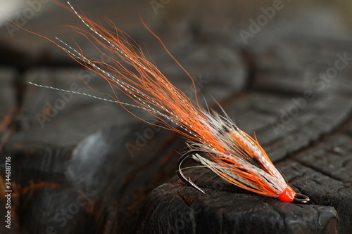 Traditionally dressed salmon fly shot against a wood background