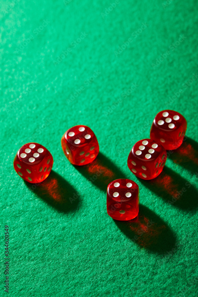 High angle view of red dice on green background High angle view of red dice on green background