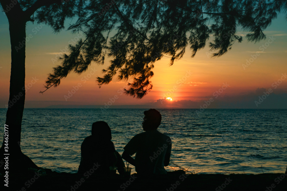 sunset view with silhuette of two people