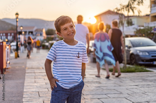 Little kid on a promenade at sunset © Victor