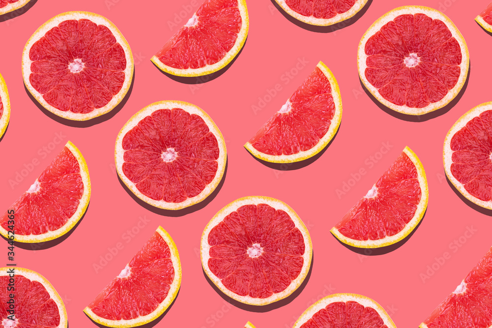 Fresh red orange or grapefruit on a peach color background. Fresh red orange or grapefruit on a peach color background.