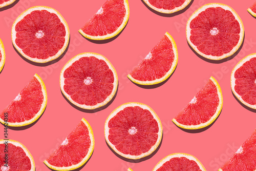 Fresh red orange or grapefruit on a peach color background.