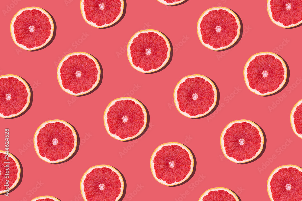 Fresh red orange or grapefruit on a peach color background. Fresh red orange or grapefruit on a peach color background.