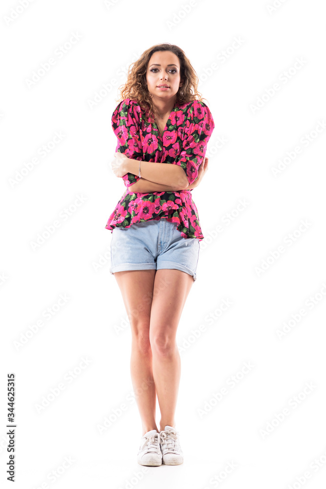 Cute young casual woman in summer clothes hugging herself shivering from feeling cold or flu. Full body length isolated on white background. Cute young casual woman in summer clothes hugging herself shivering from feeling cold or flu. Full body length isolated on white background.