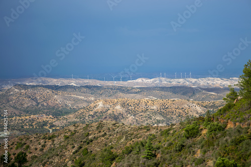 A wind farm is located along a picturesque valley.