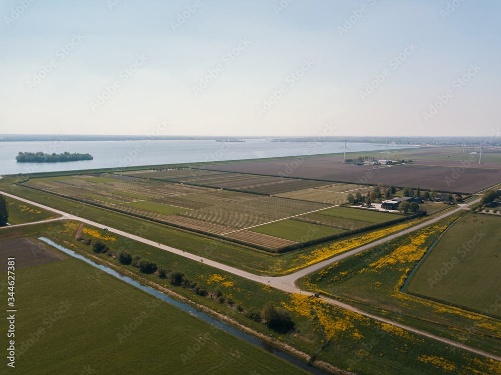 Beautiful aerial drone shot of the flat landscape of the Netherlands.